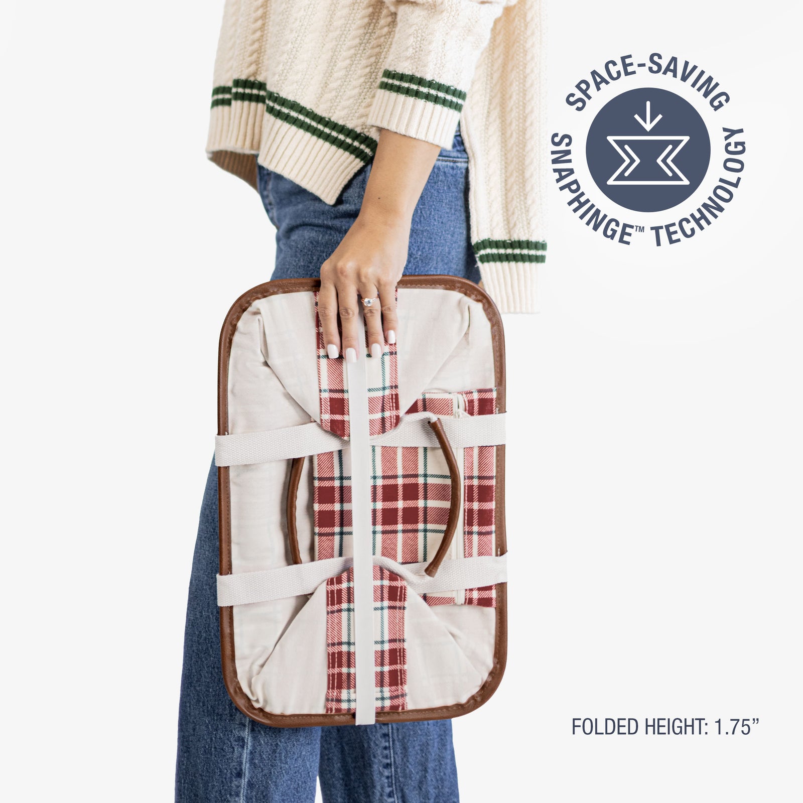 Person holding a folded tote bag with 'Space-Saving Snap hinge Technology' label.
