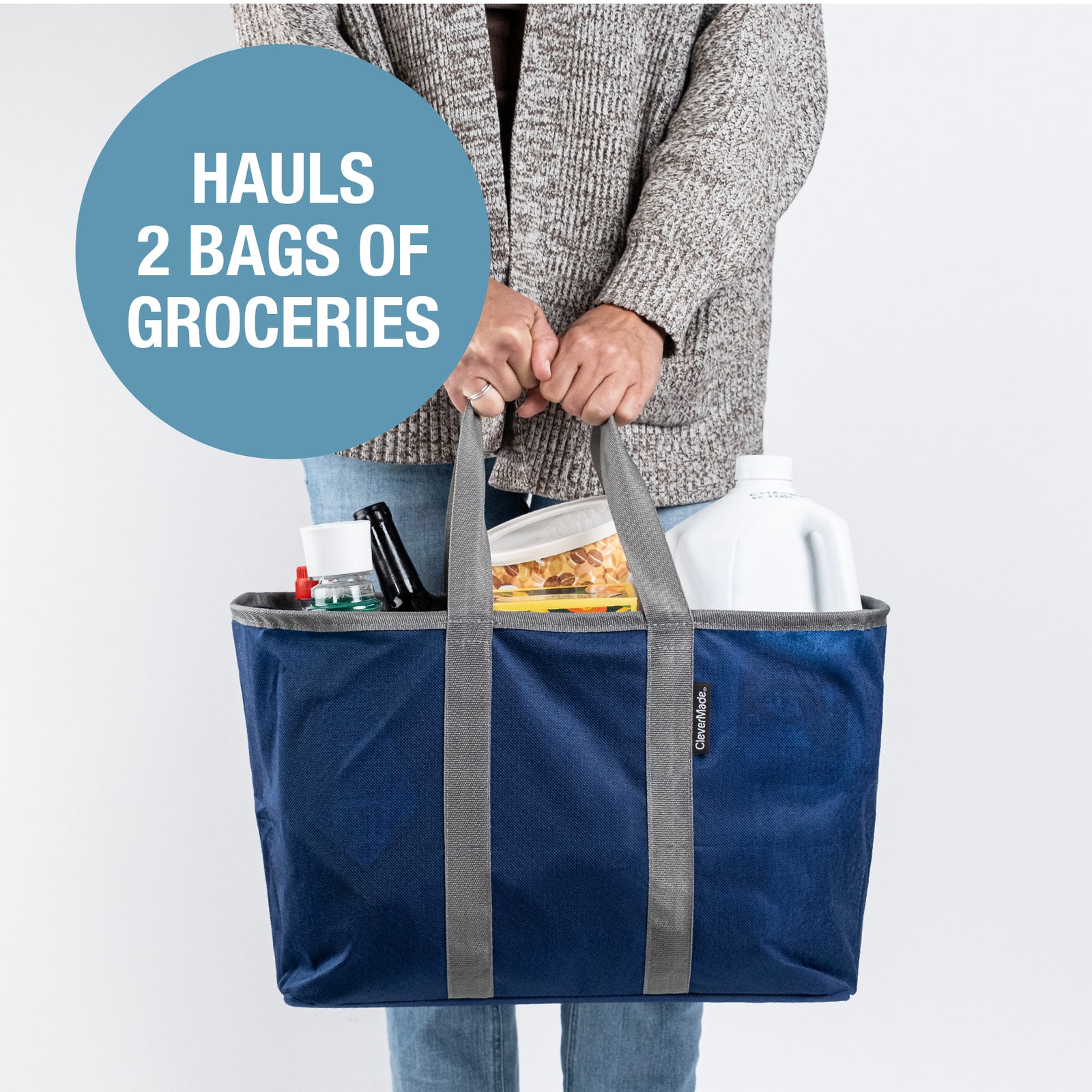 A person holding a blue and gray pop-up tote with groceries