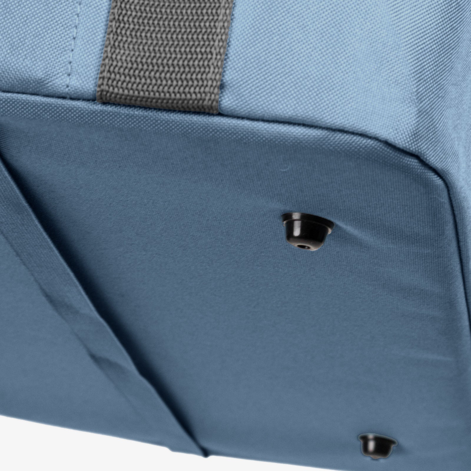 Close-up of a blue bag with a strap and visible stitching details.