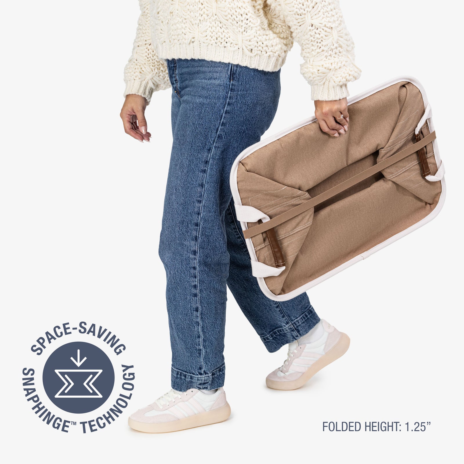 Person holding a folded collapsible laundry basket LUXE with space-saving snaphinge technology label