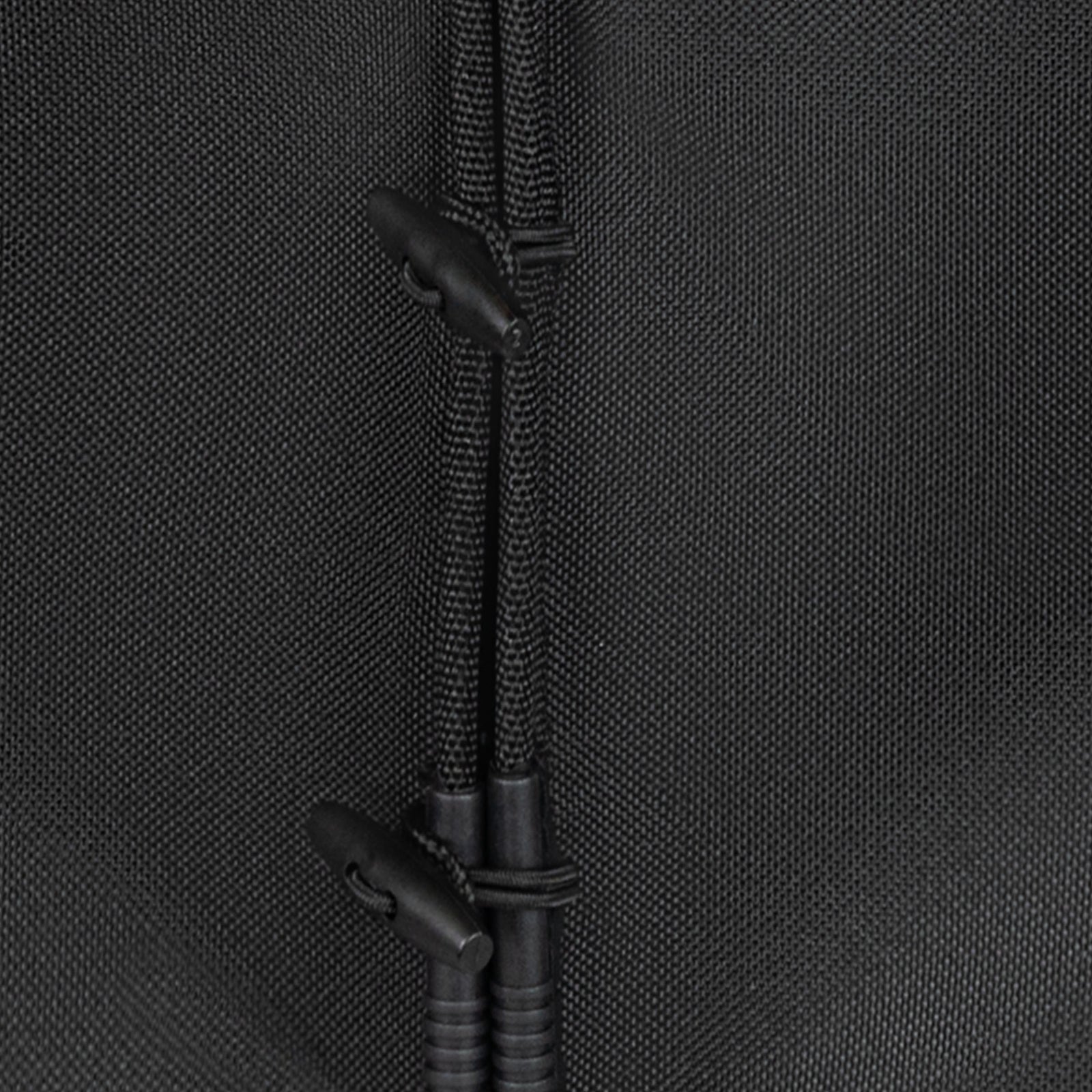 Close-up of a black connector on a textured black fabric