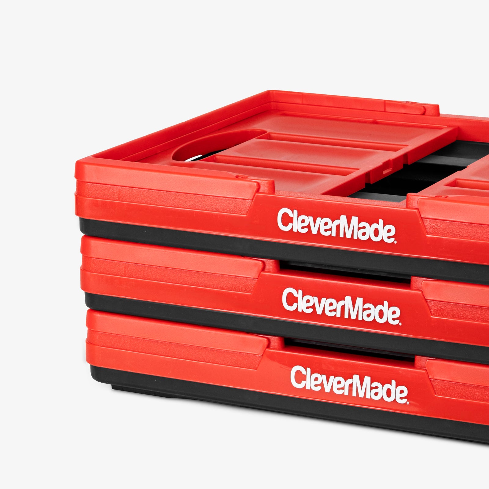 Stack of red CleverMade collapsible basket on a white background