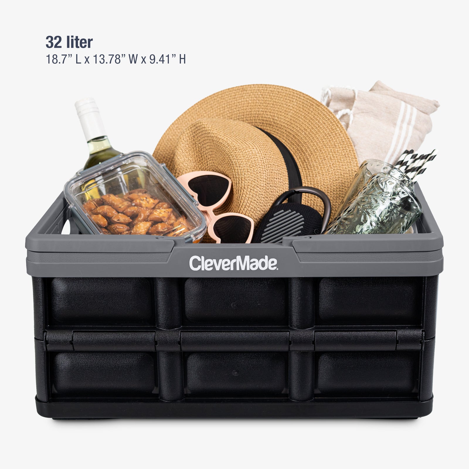 Black CleverMade storage crate with items like a hat, sunglasses, and snacks on a white background