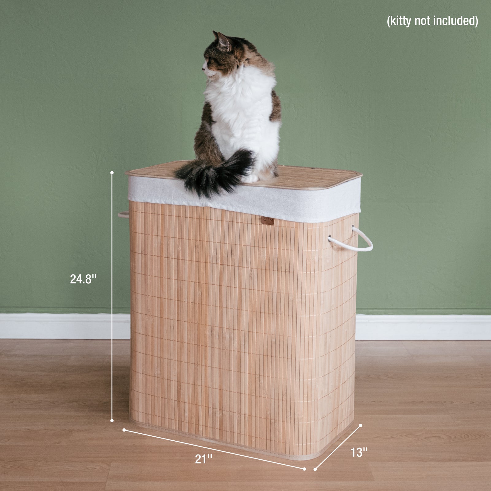 A collapsible bamboo laundry hamper with dimensions and cat on top