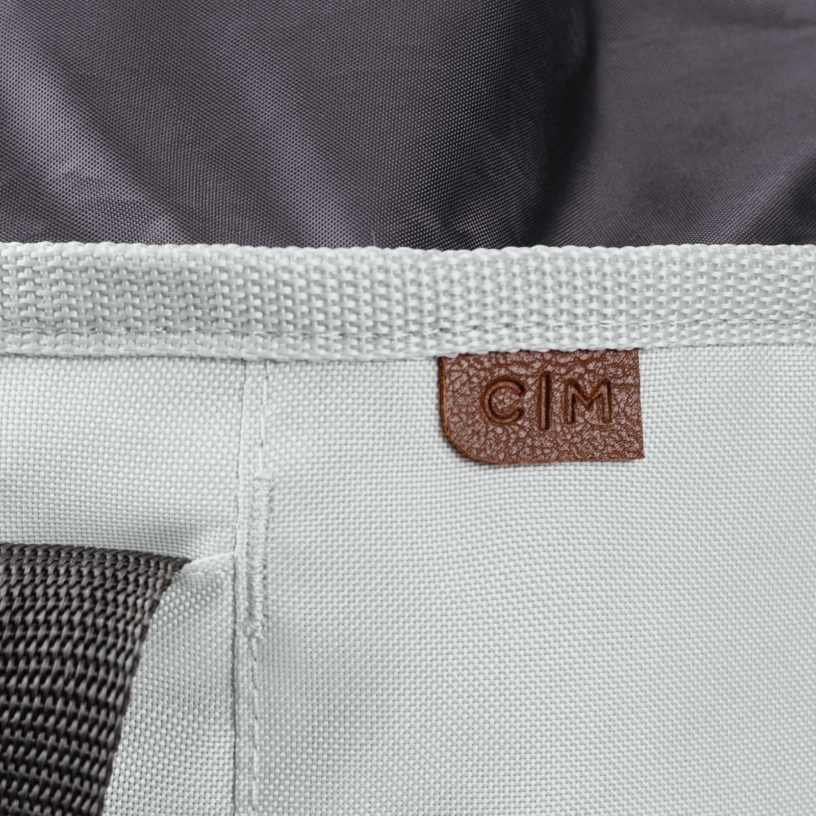 Close-up of a laundry backpack duffel bag with a visible brand label C|M on a white background
