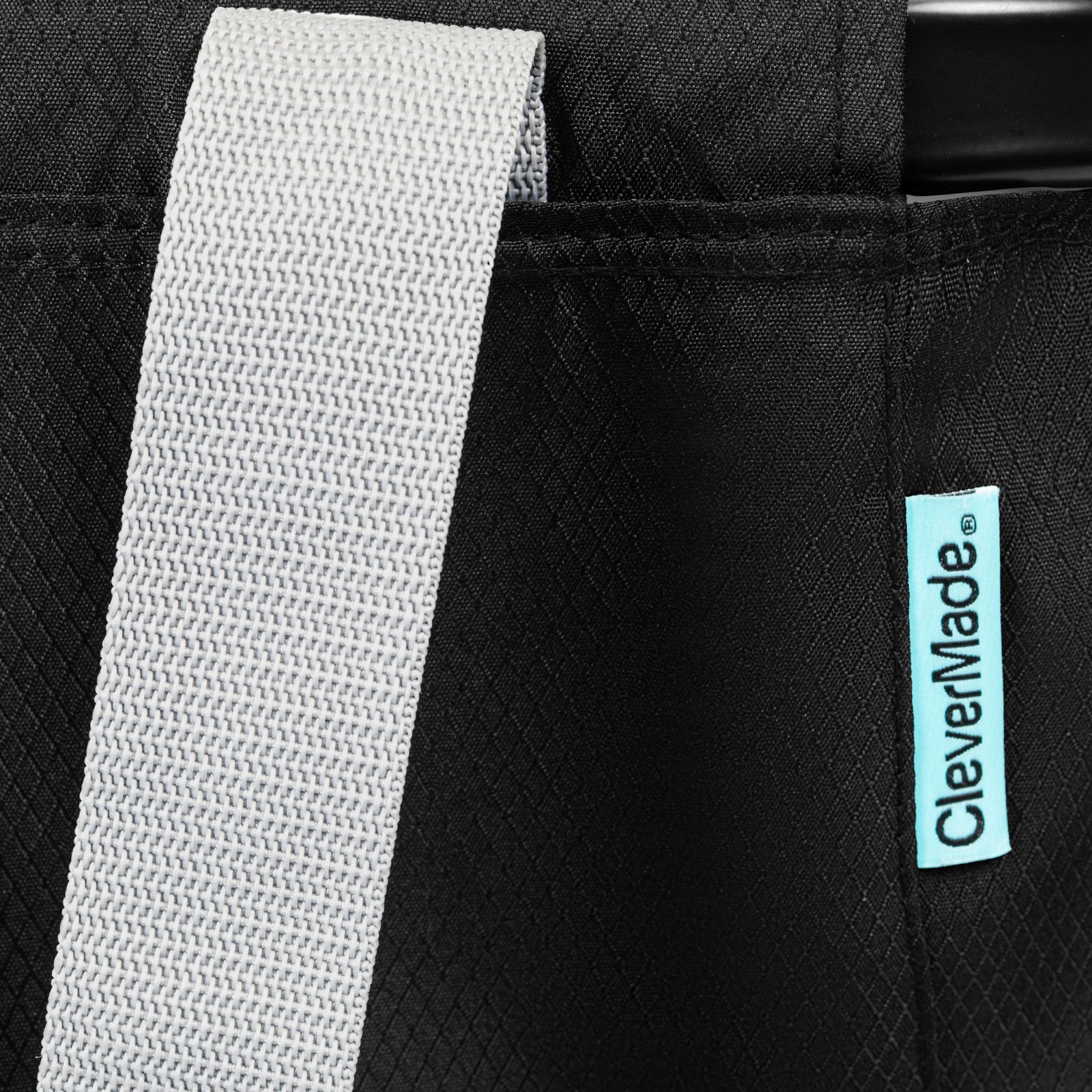 Close-up of a black bag with a gray strap and CleverMade logo.
