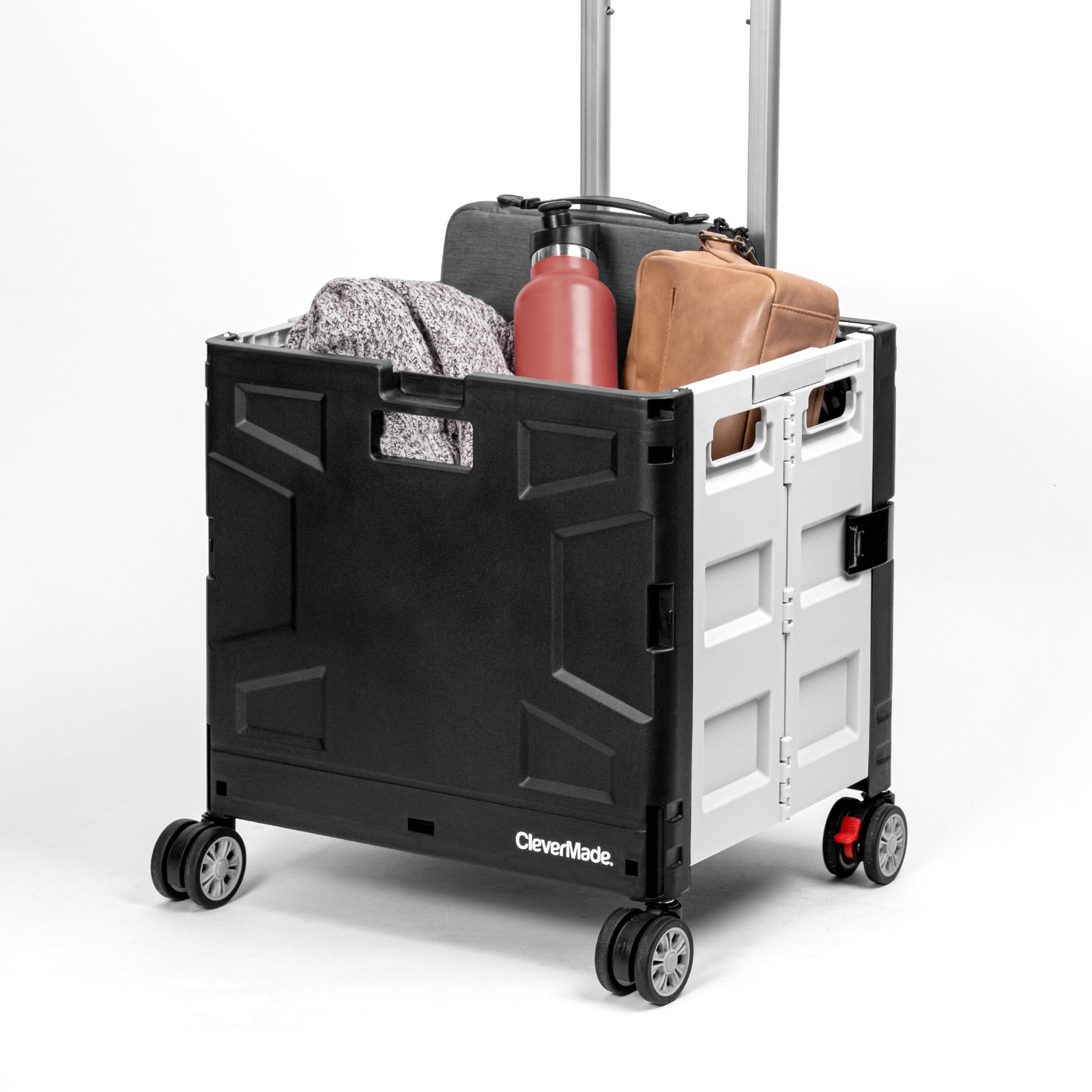 A collapsible wheeled crate with four wheels carrying bags and other stuffs