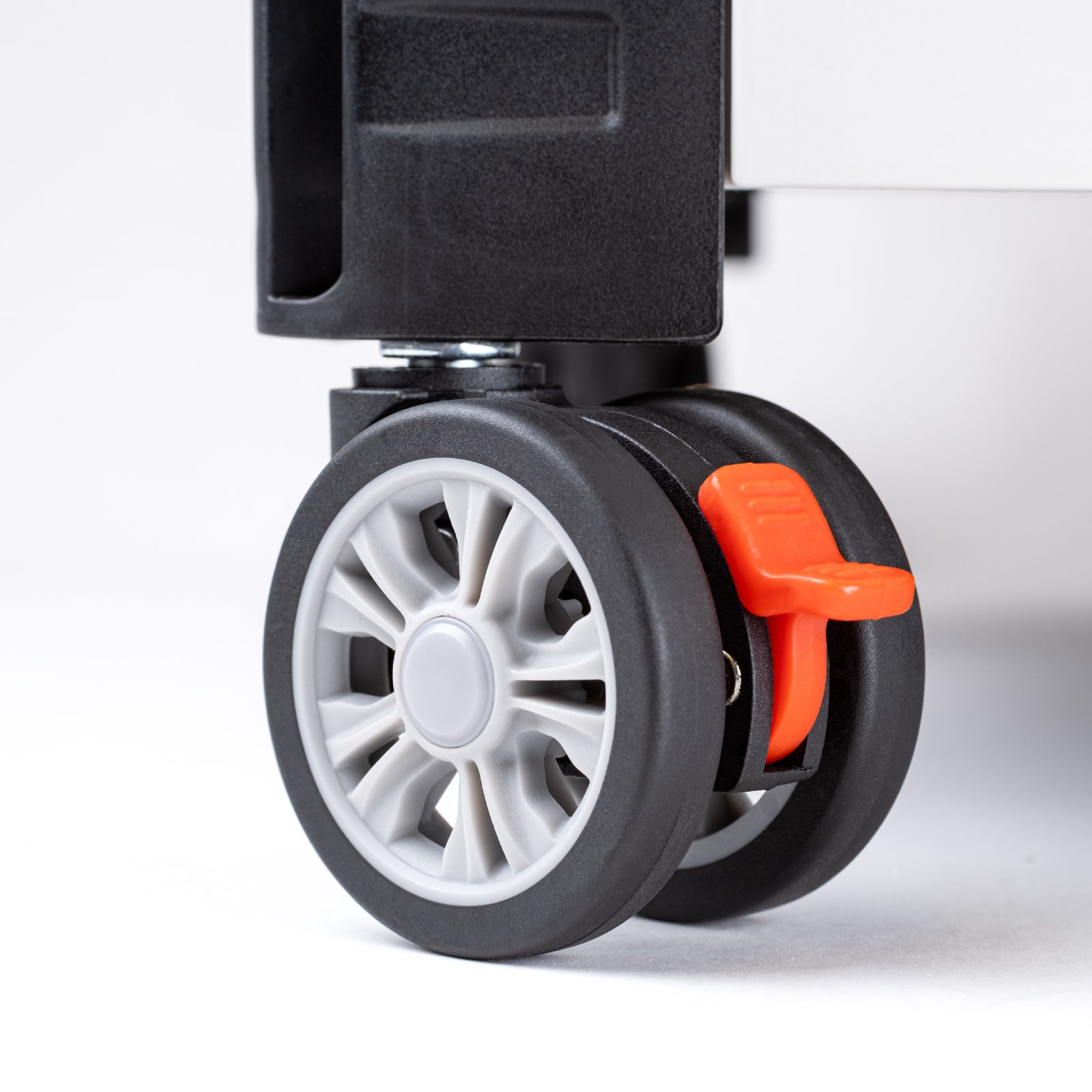 Close up view of wheels (with lock) of a collapsible wheeled crate