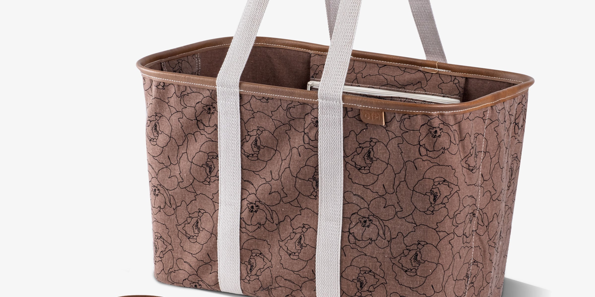 Brown floral-patterned tote bag with white straps on a white background
