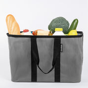 A gray and black pop-up tote with groceries inside