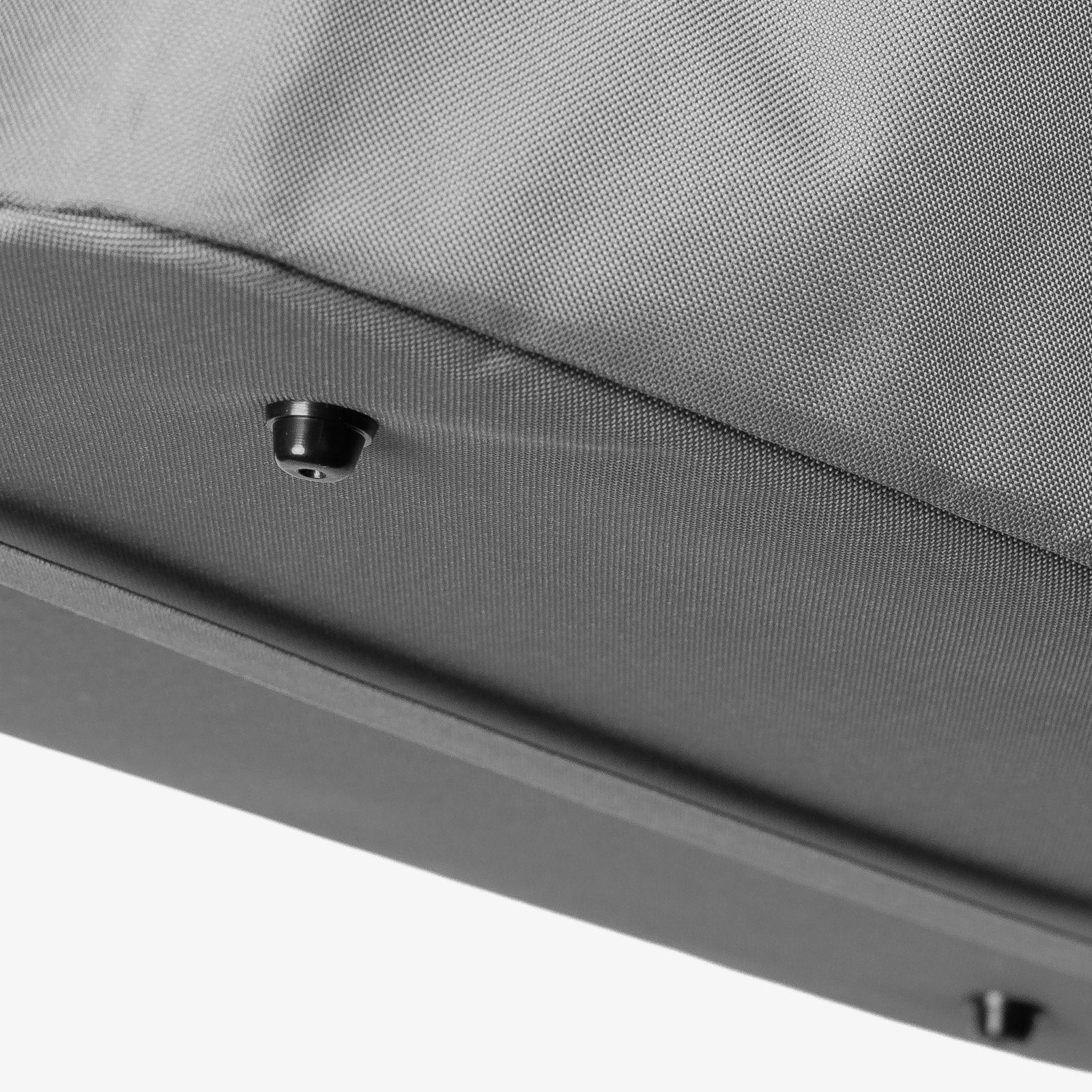 Close-up of a gray fabric surface with a small button foot