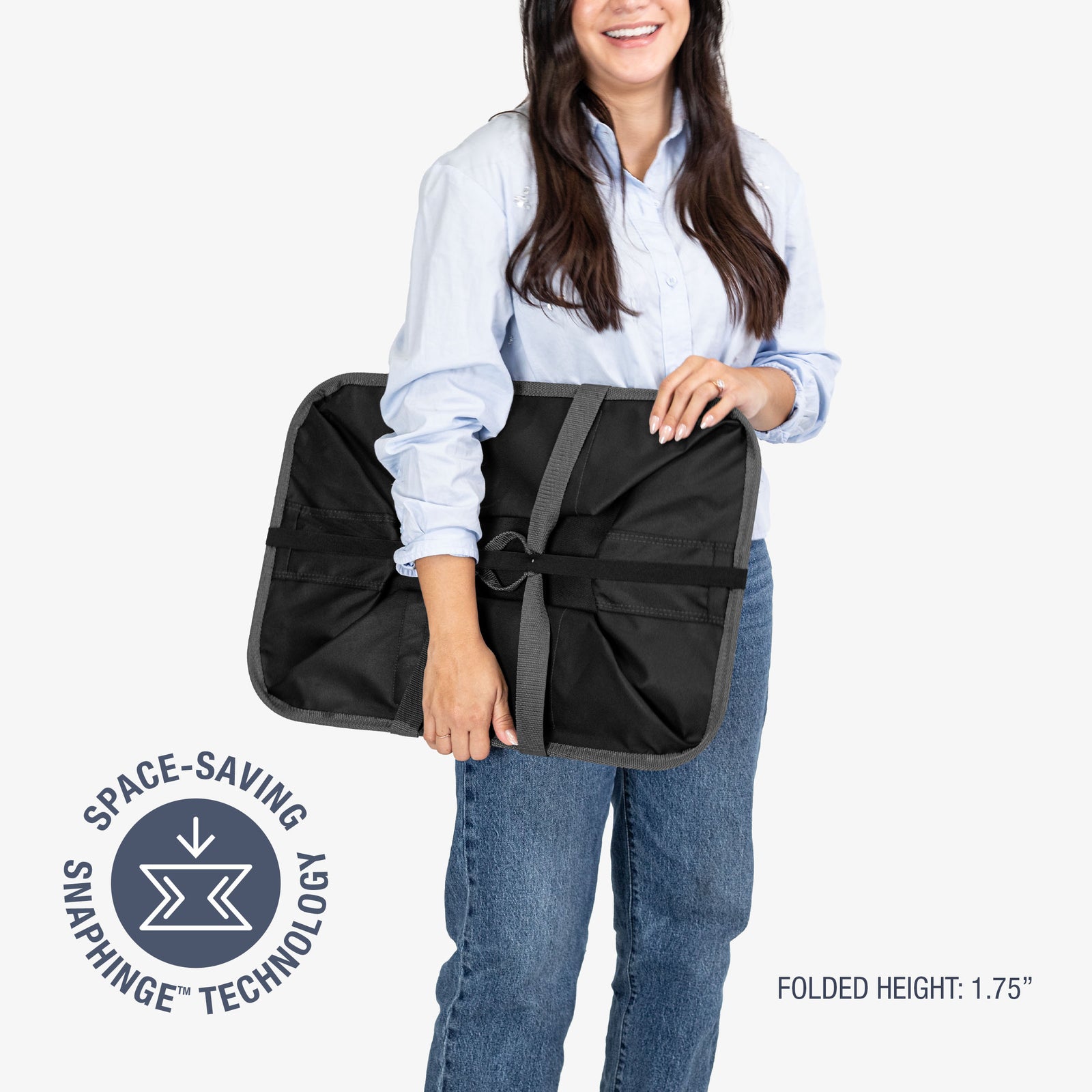 Woman holding a black and gray bag with space-saving snapping technology logo