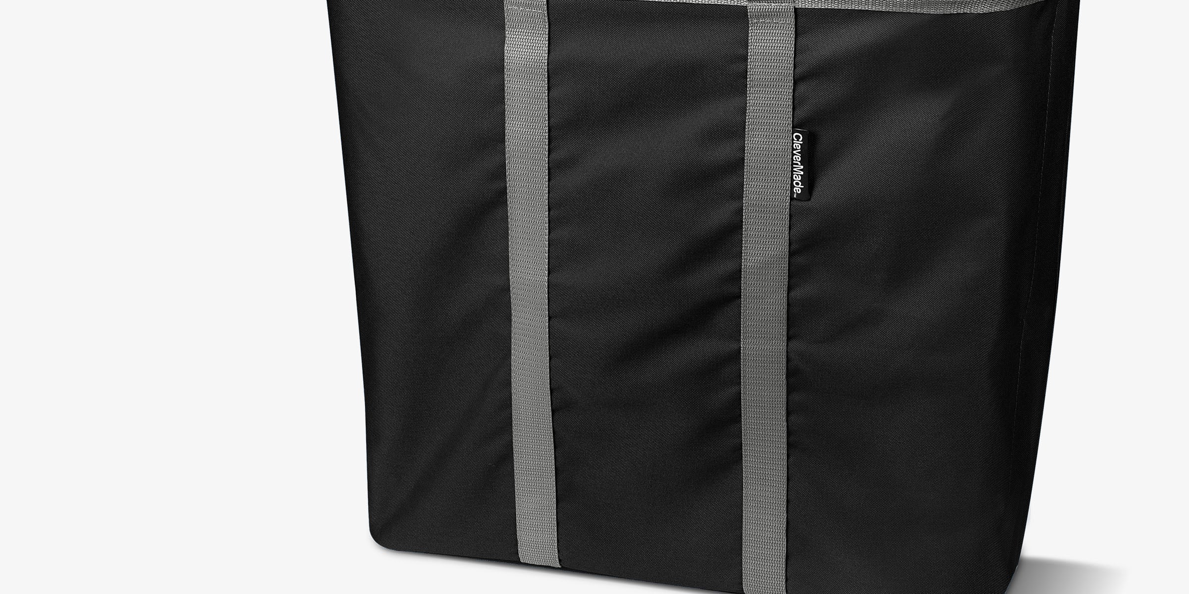 Black and gray laundry caddy with a smaller version below on a white background