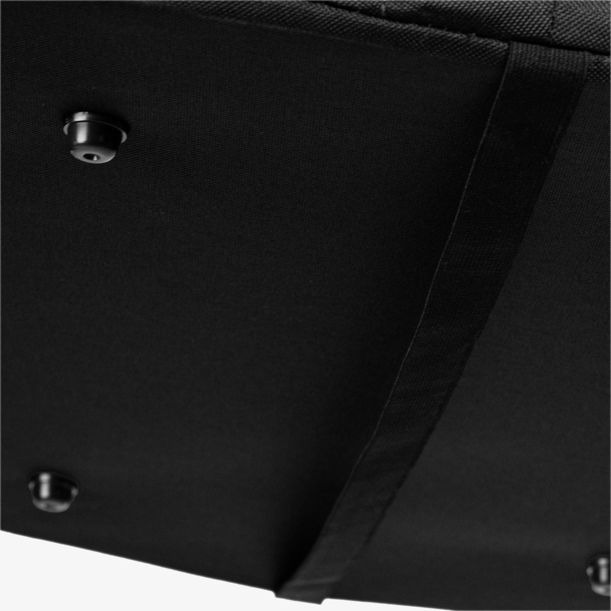 Close-up of a black laundry caddy with a visible stitching detail