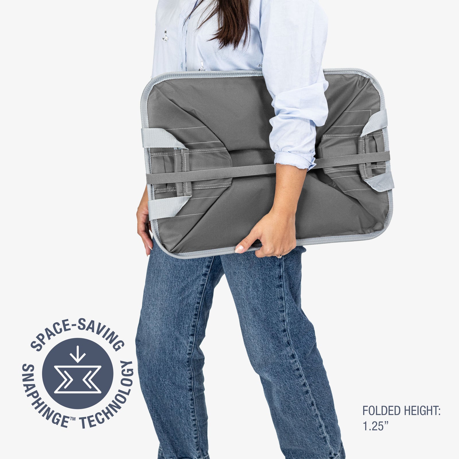 Person holding a gray collapsible laundry basket with space-saving snaphinge technology label