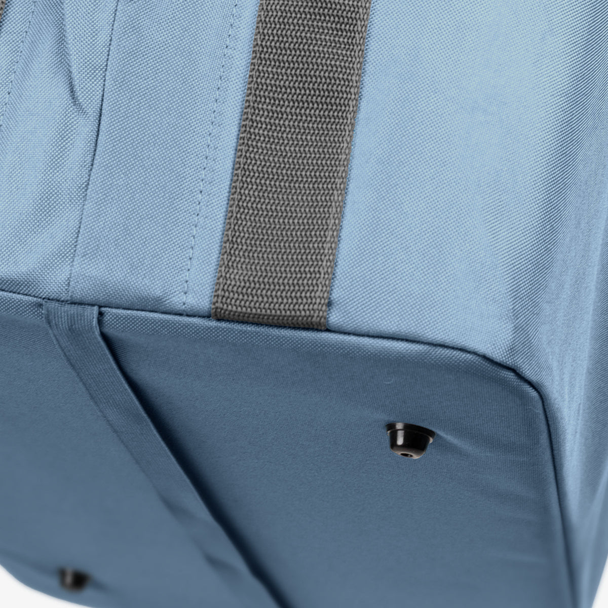 Close-up of a blue collapsible laundry basket with a brown strap on a white background