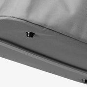 Close-up of a gray fabric surface with a small black object on it.