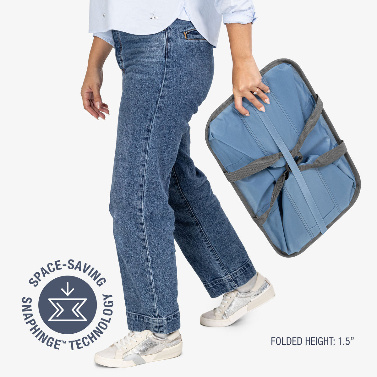 Person holding a blue folding laundry tote bag with 'Space-Saving Snap Hinge Technology' label.