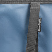 Close-up of a blue bag with a gray strap and CleverMade logo.