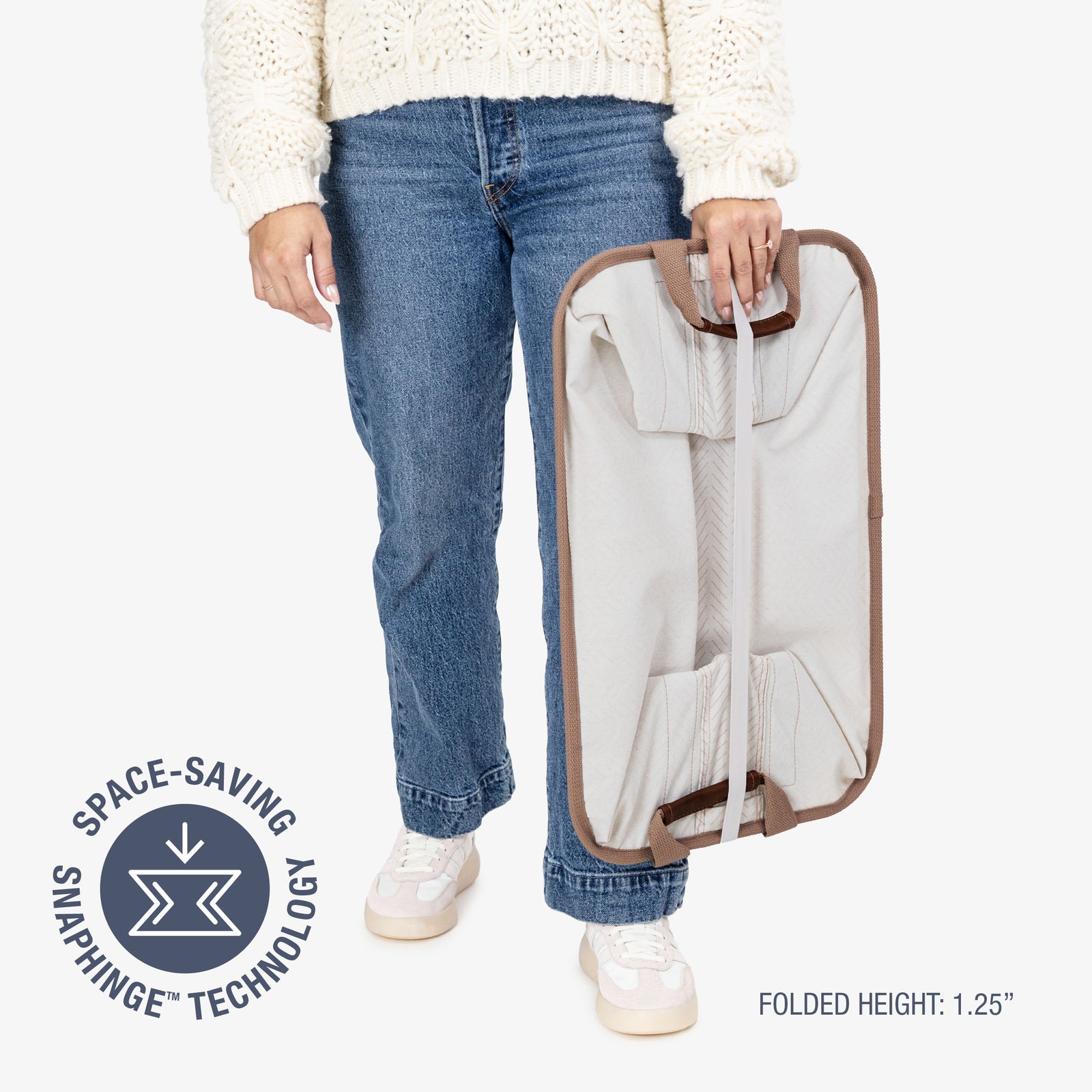 Person holding a folded collapsible laundry basket LUXE with space-saving snaphinge technology label