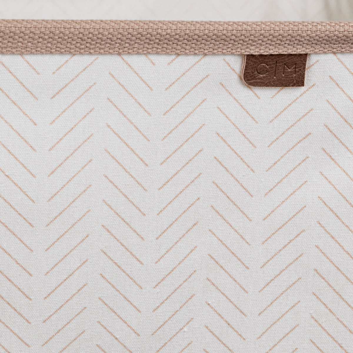 Close up collapsible laundry basket LUXE with brown brand label C|M