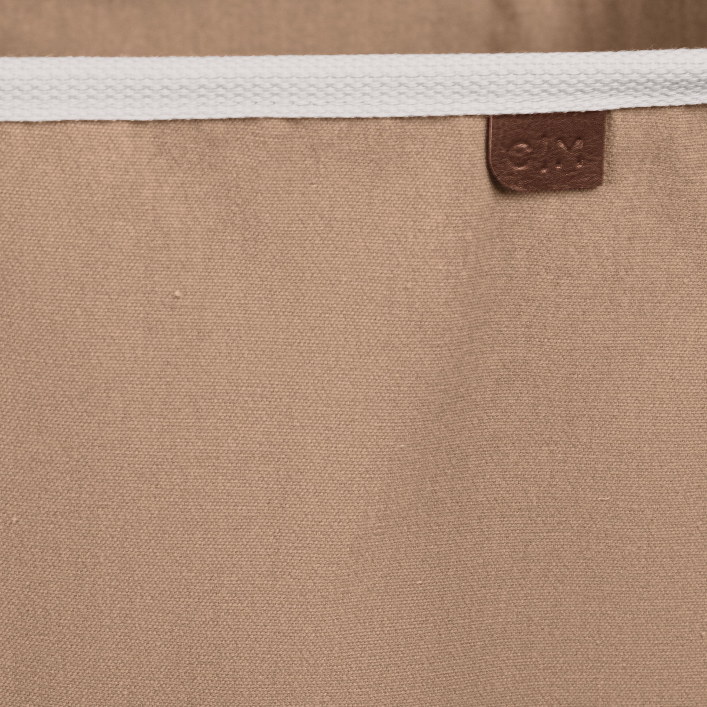 Close up collapsible laundry basket LUXE with brown brand label C|M