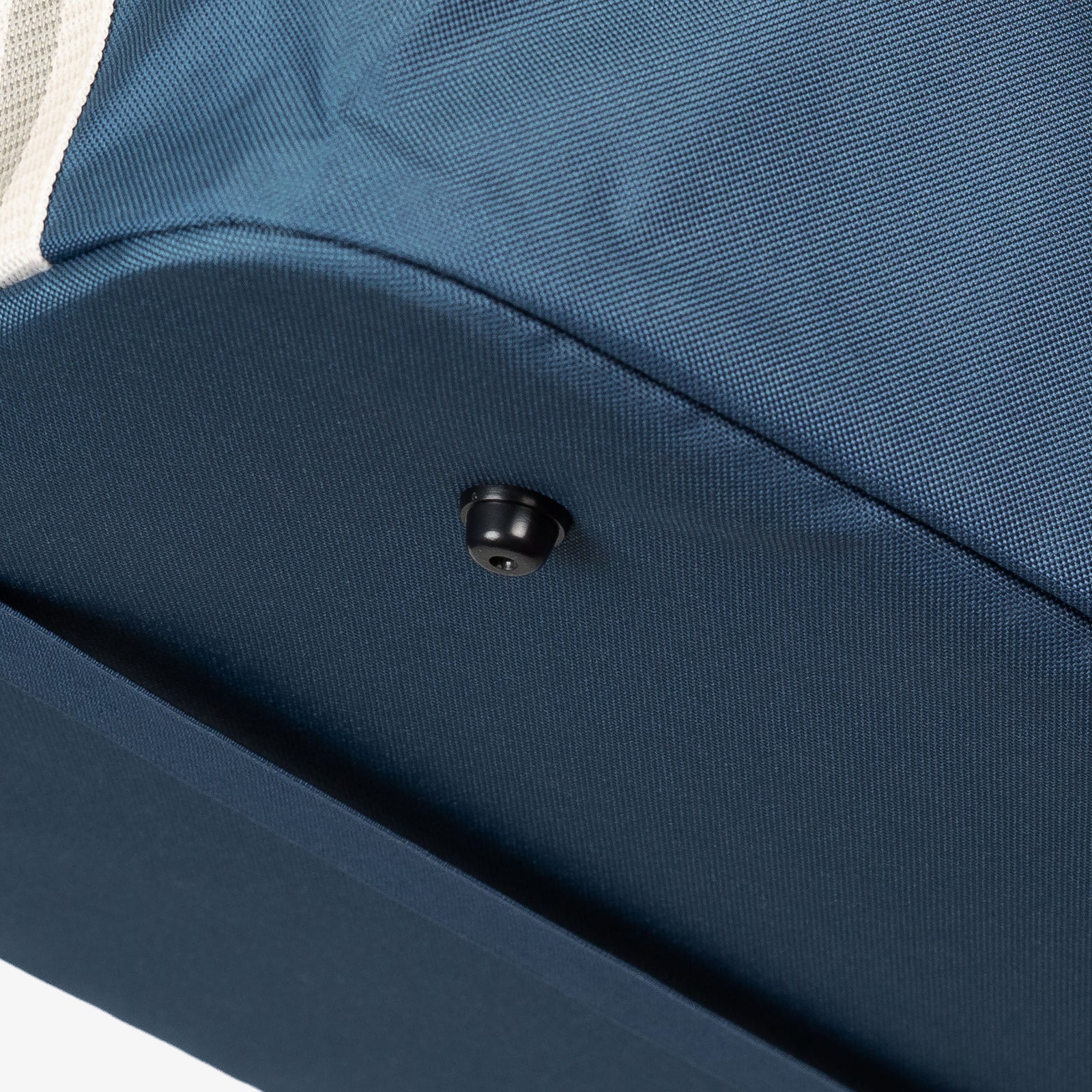 Close-up of a blue collapsible laundry basket with a button foot