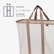 Tapered tote bag with brown handles and white body on a white background