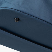 Close-up of a blue fabric surface with a button