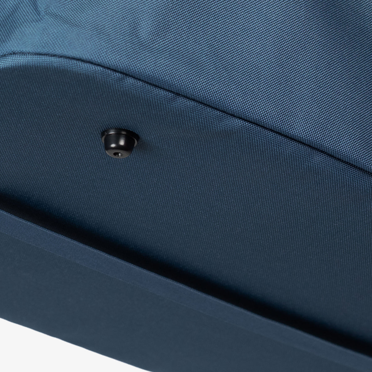Close-up of a blue fabric surface with a button