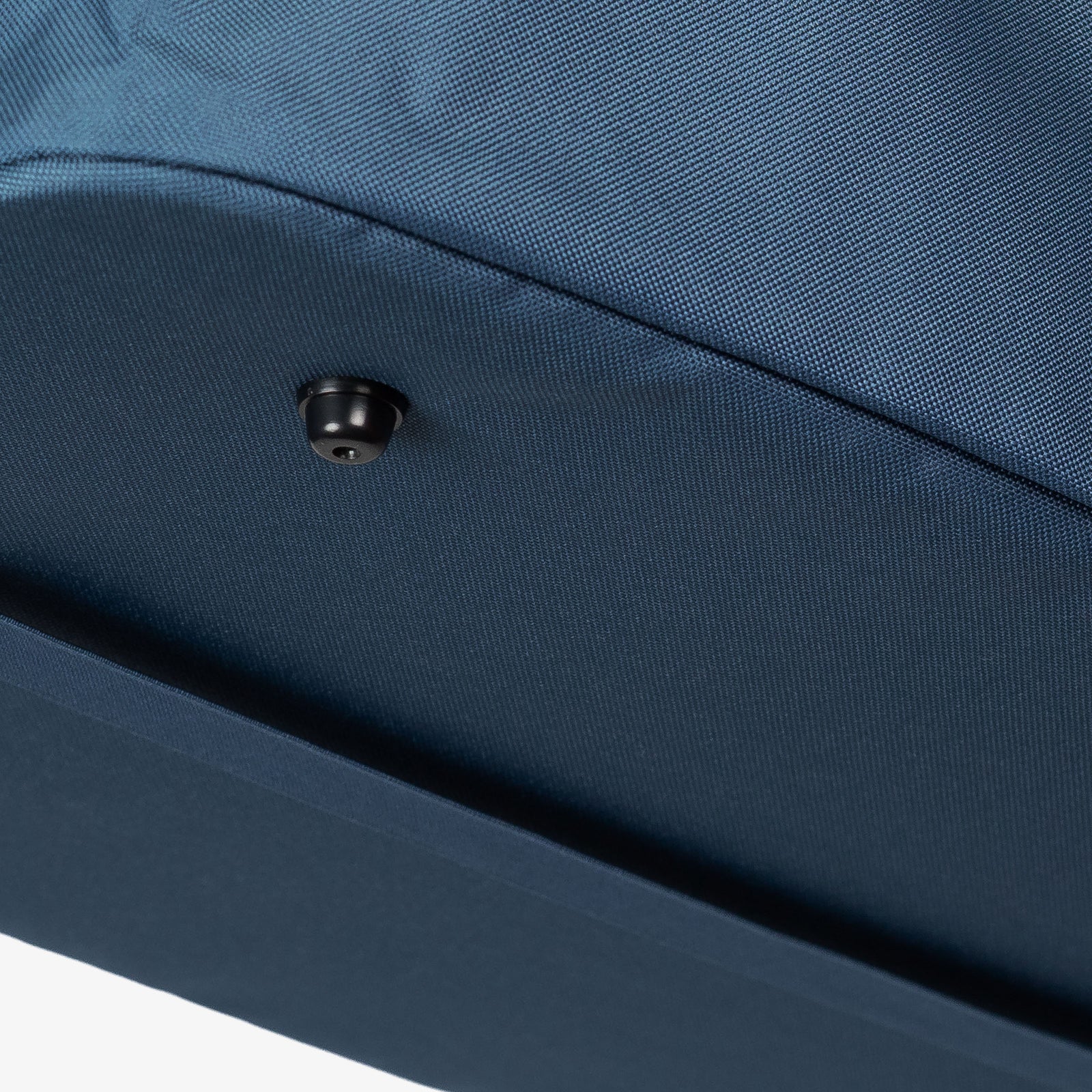 Close-up of a blue fabric surface with a button