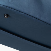 Close-up of a blue fabric surface with a button detail