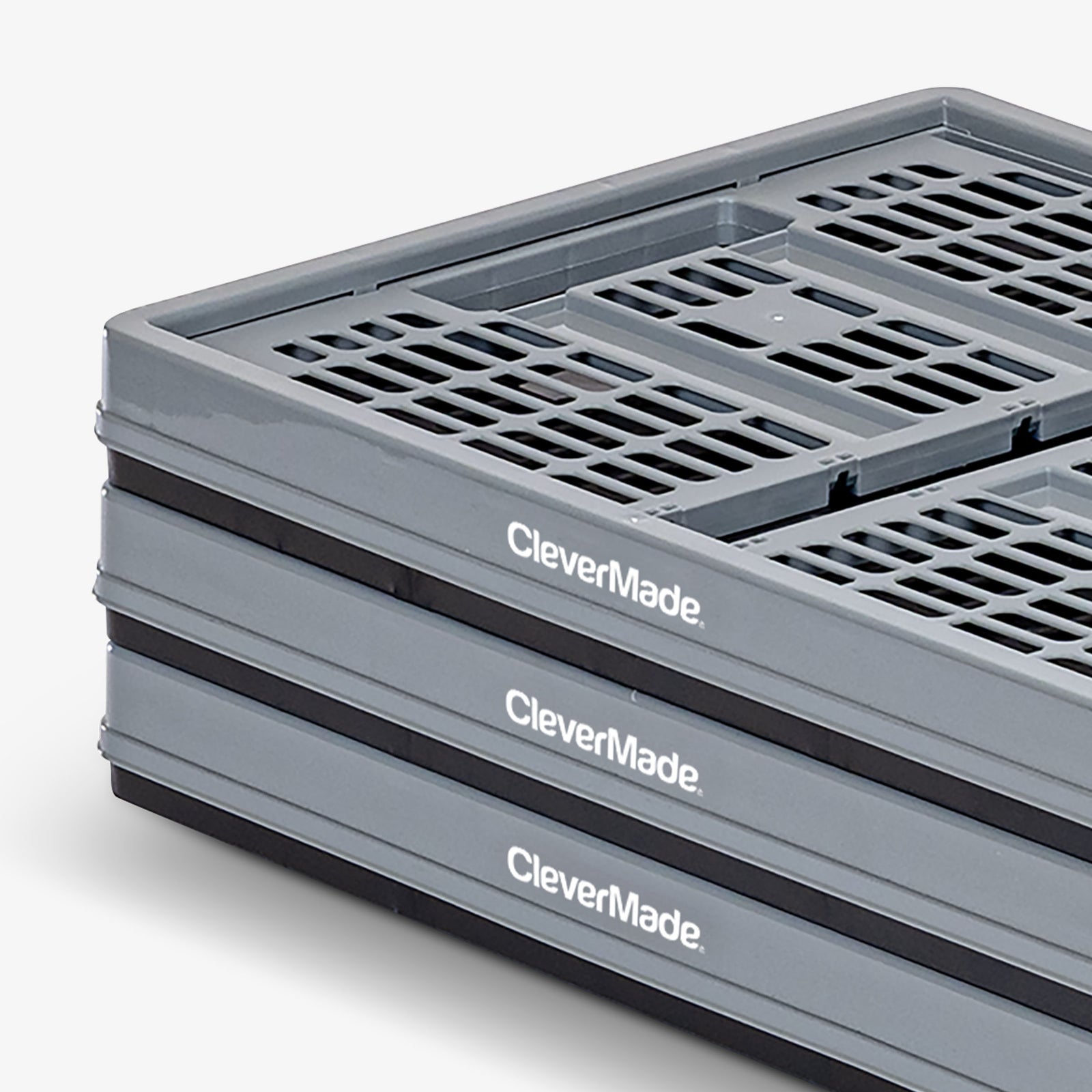 Stack of gray CleverMade collapsible containers on a white background