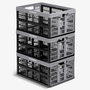 Stack of three gray CleverMade collapsible utility crates on a white background