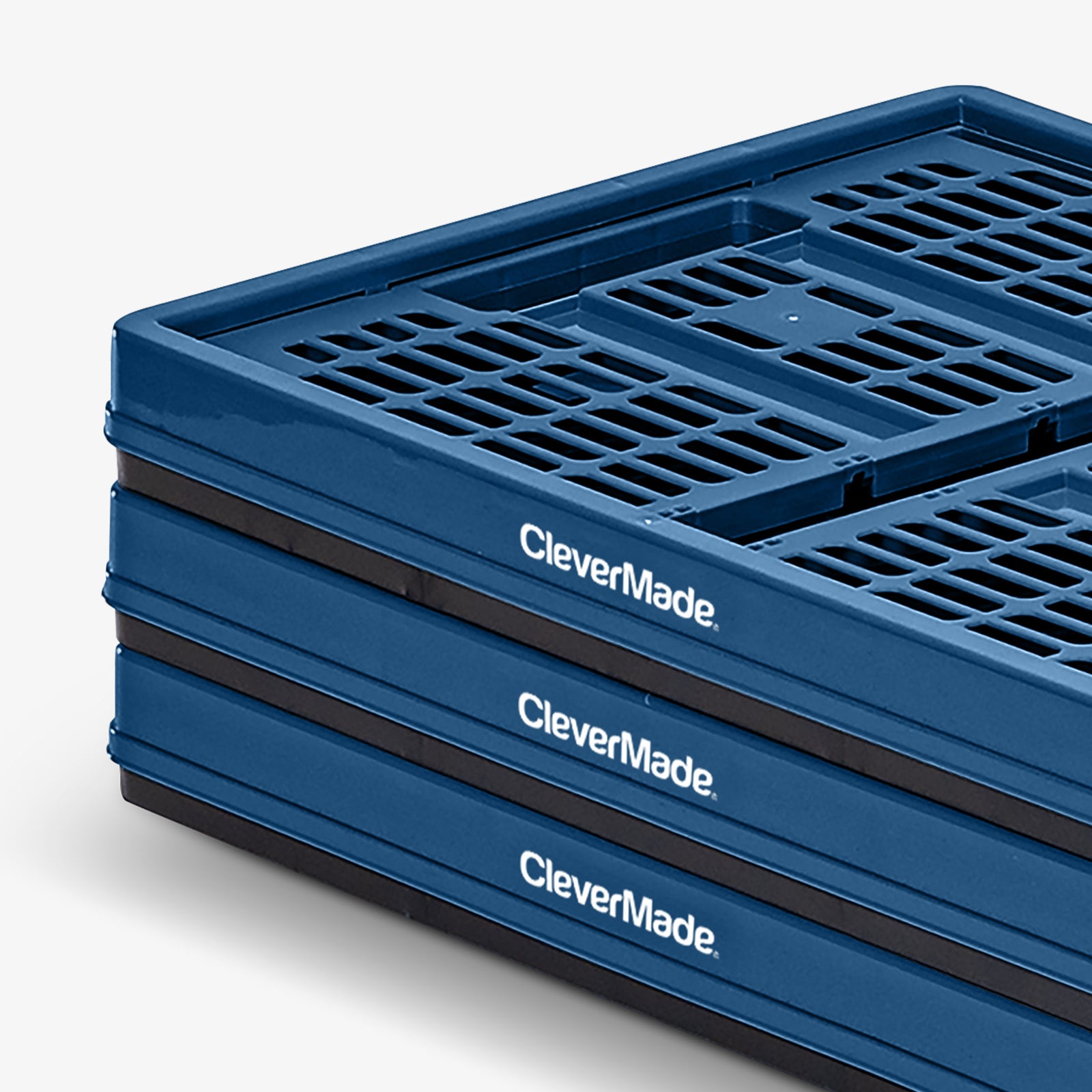 Stack of blue CleverMade collapsible utility crates on a white background