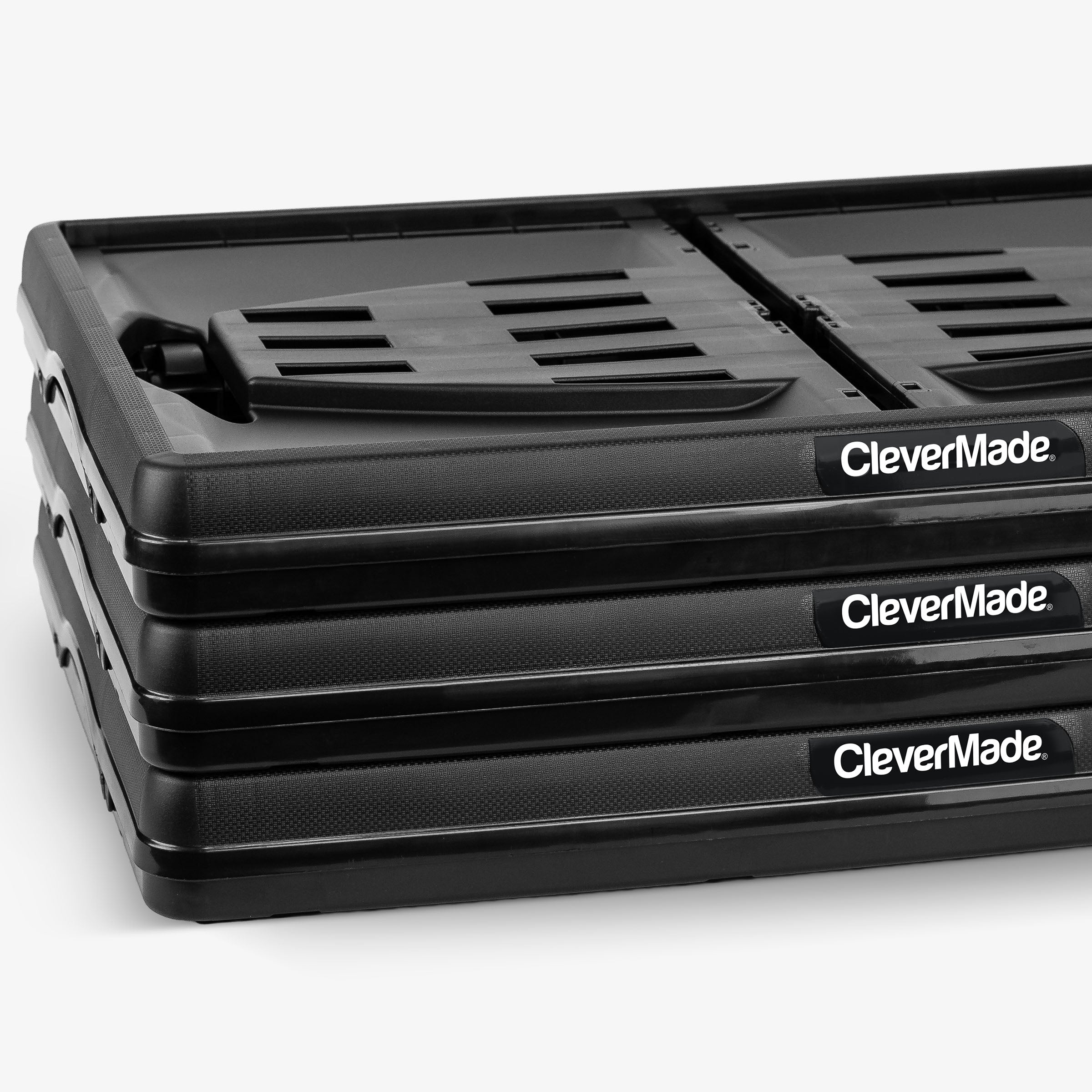 Stack of 3 folded black CleverMade Black collapsible storage crate on a white background
