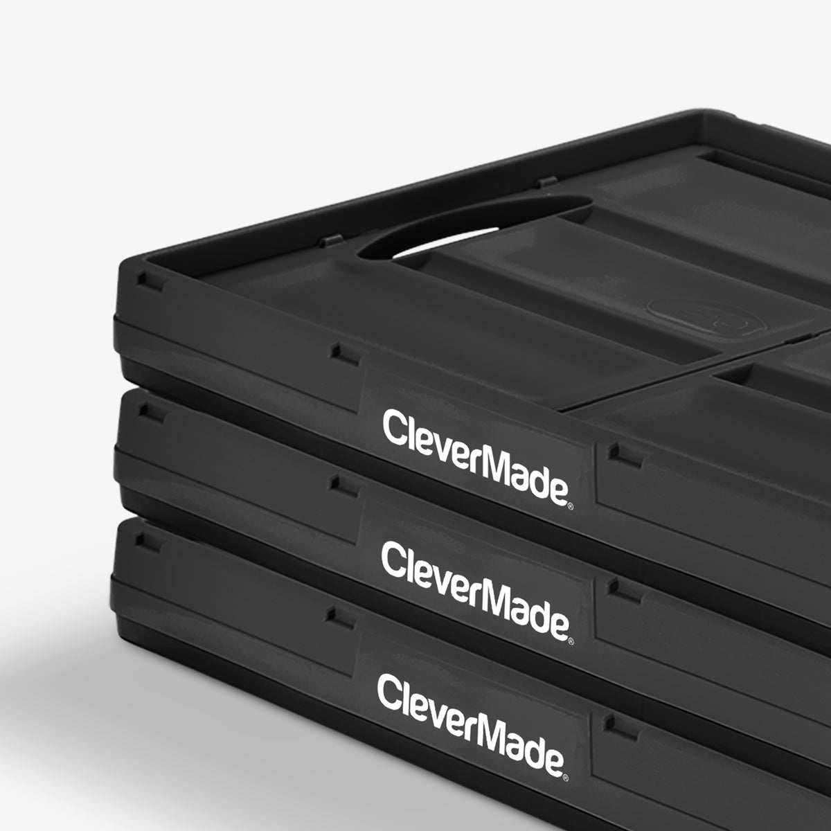 Folded three-pack 62L black stackable collapsible storage bin with CleverMade logo