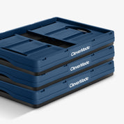 Stack of folded blue CleverMade trays on a white background