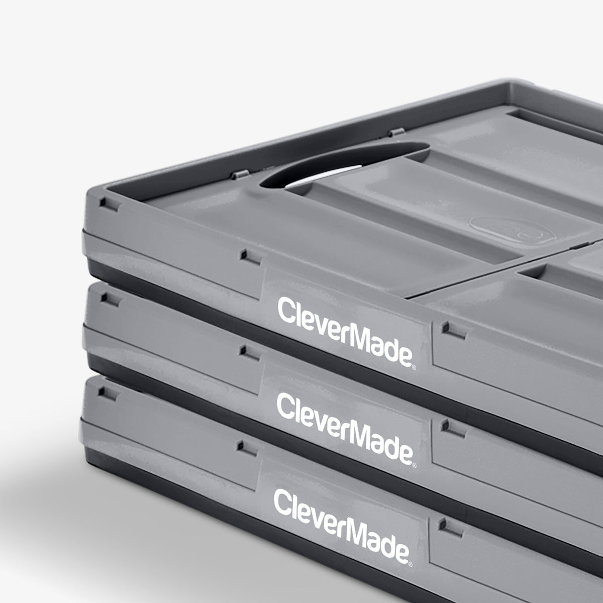 Folded three-pack 62L gray-black stackable collapsible storage bin with CleverMade logo