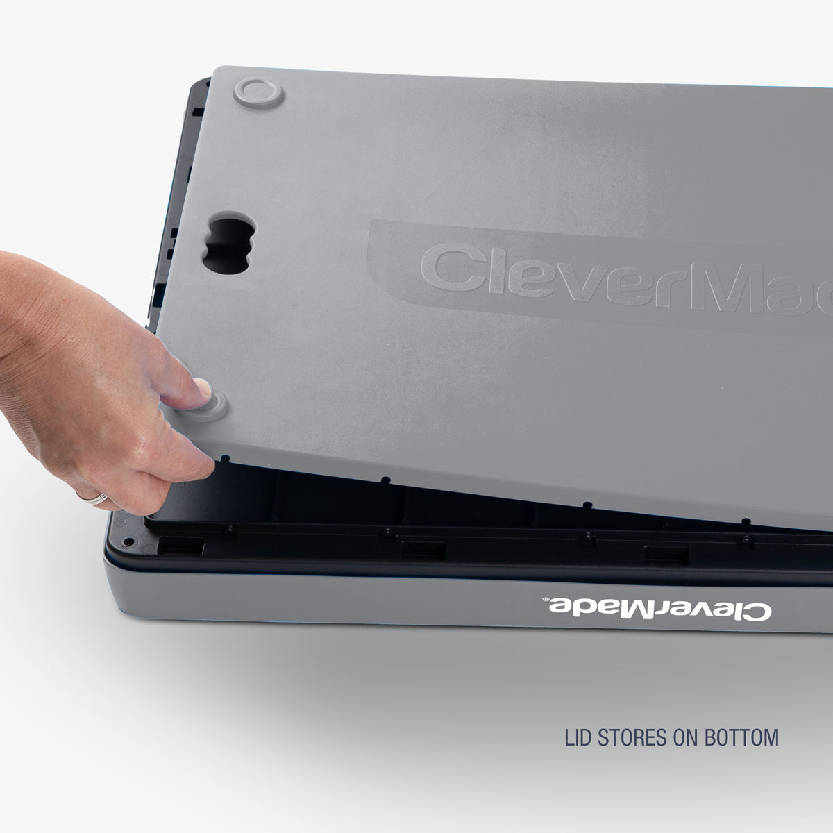 A gray and black collapsible storage bins with lid with the brand name 'CleverMade' visible on the lid that stores on the bottom