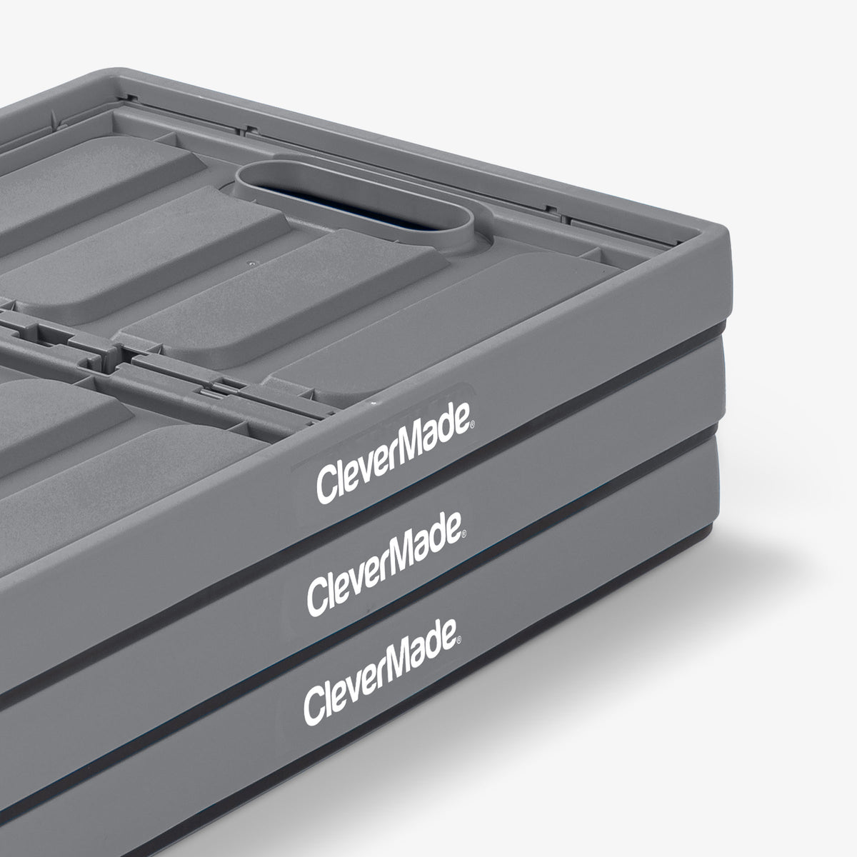 Folded three-pack gray and black collapsible storage bin with lid with 'CleverMade' branding on a white background