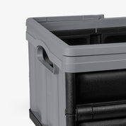 Gray storage crate with black interior on a white background