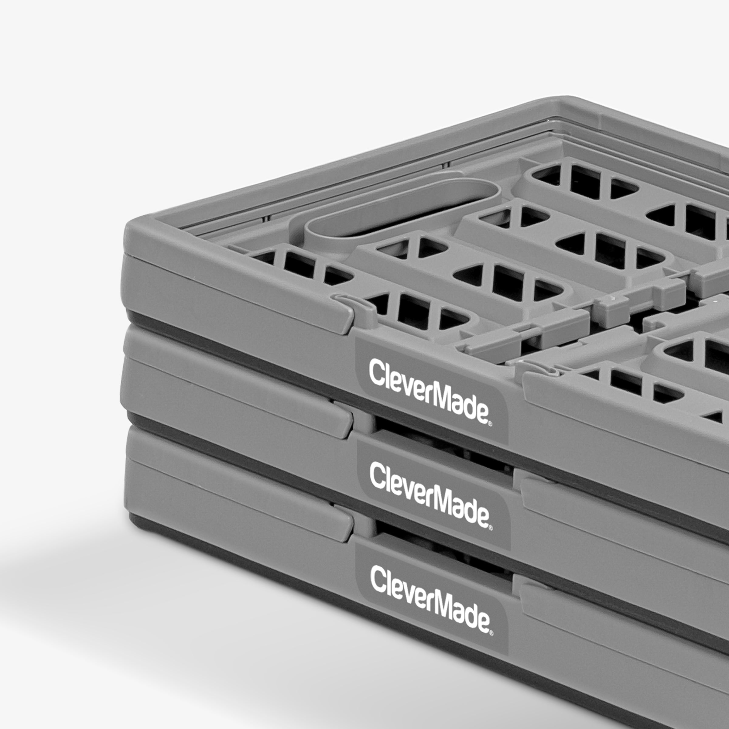 A three-pack folded gray-black collapsible shopping basket with CleverMade logo