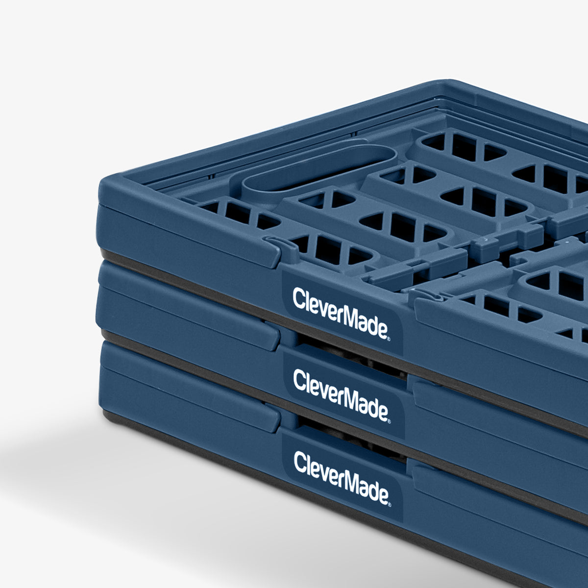 Folded three-pack navy and black stackable collapsible shopping basket with CleverMade logo