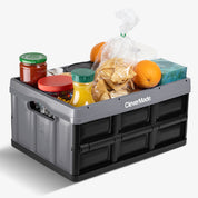 A gray-black collapsible storage bin for carrying groceries