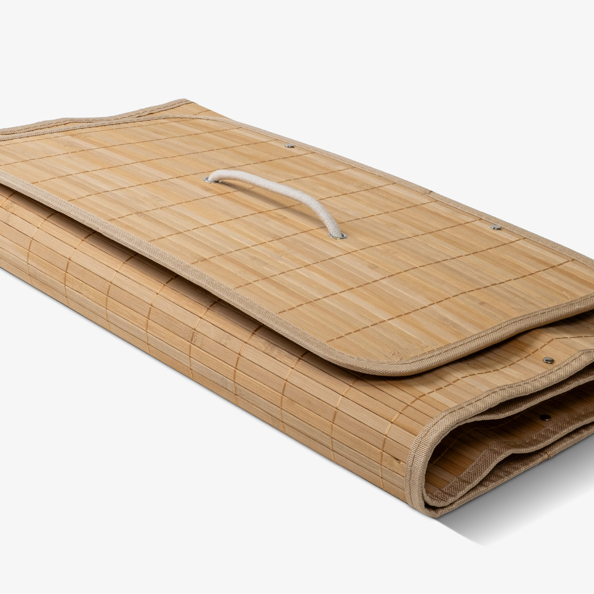 Folded collapsible bamboo laundry hamper with a lid and handles, featuring a natural beige color.