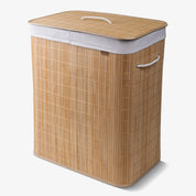 A fully built collapsible bamboo laundry hamper with a lid and handles, featuring a natural beige color.