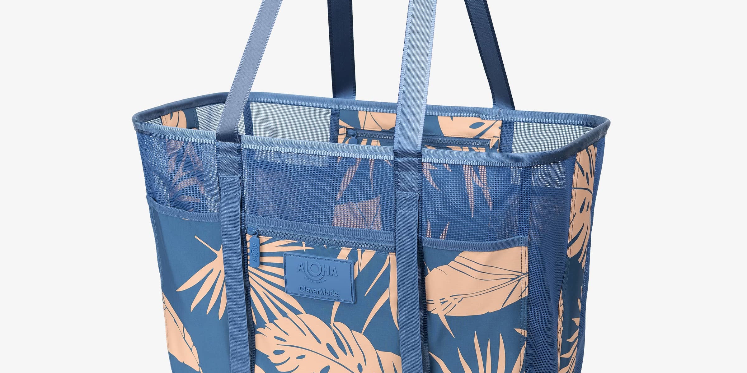 Blue tote bag with leaf pattern on a white background