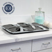 Folded gray collapsible tote MAX with straps on a kitchen counter, featuring 'Space-Saving SnapHinge Technology' logo.