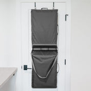 Gray hanging convertible laundry hamper bag on a white door